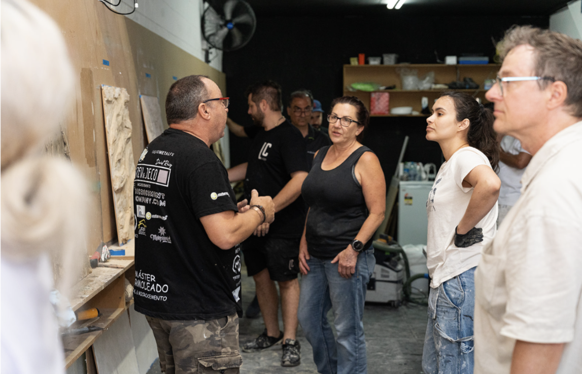 Group of people in a microcement and Italian polished plaster workshop 